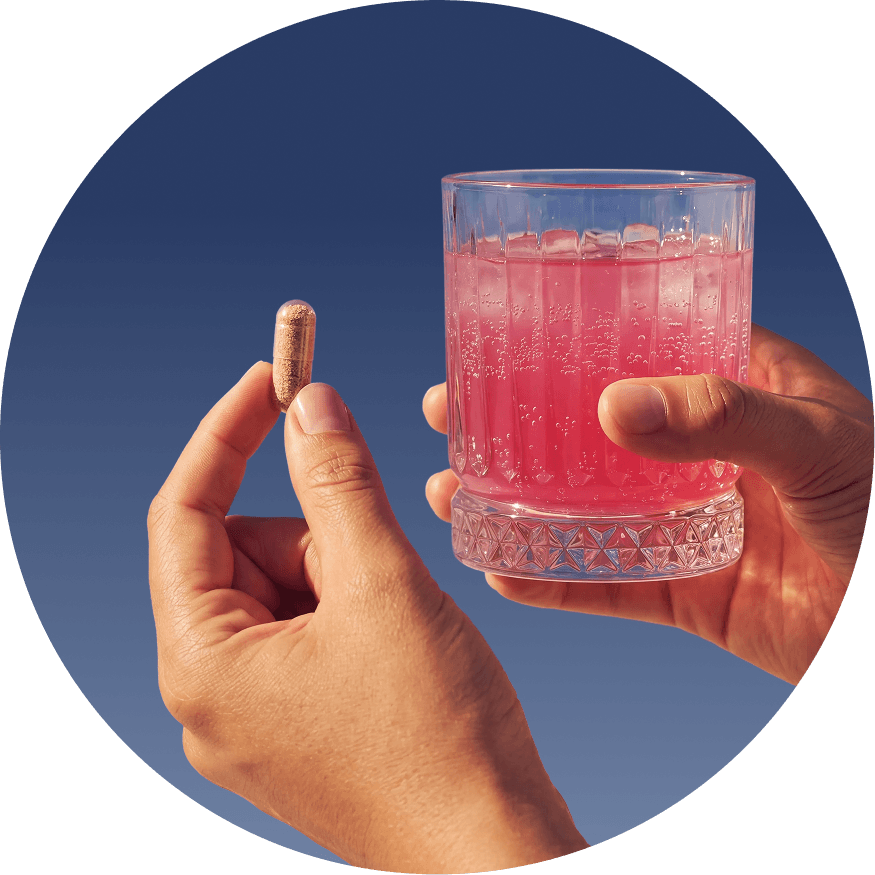Hands holding Immortals longevity supplement capsule and refreshing drink