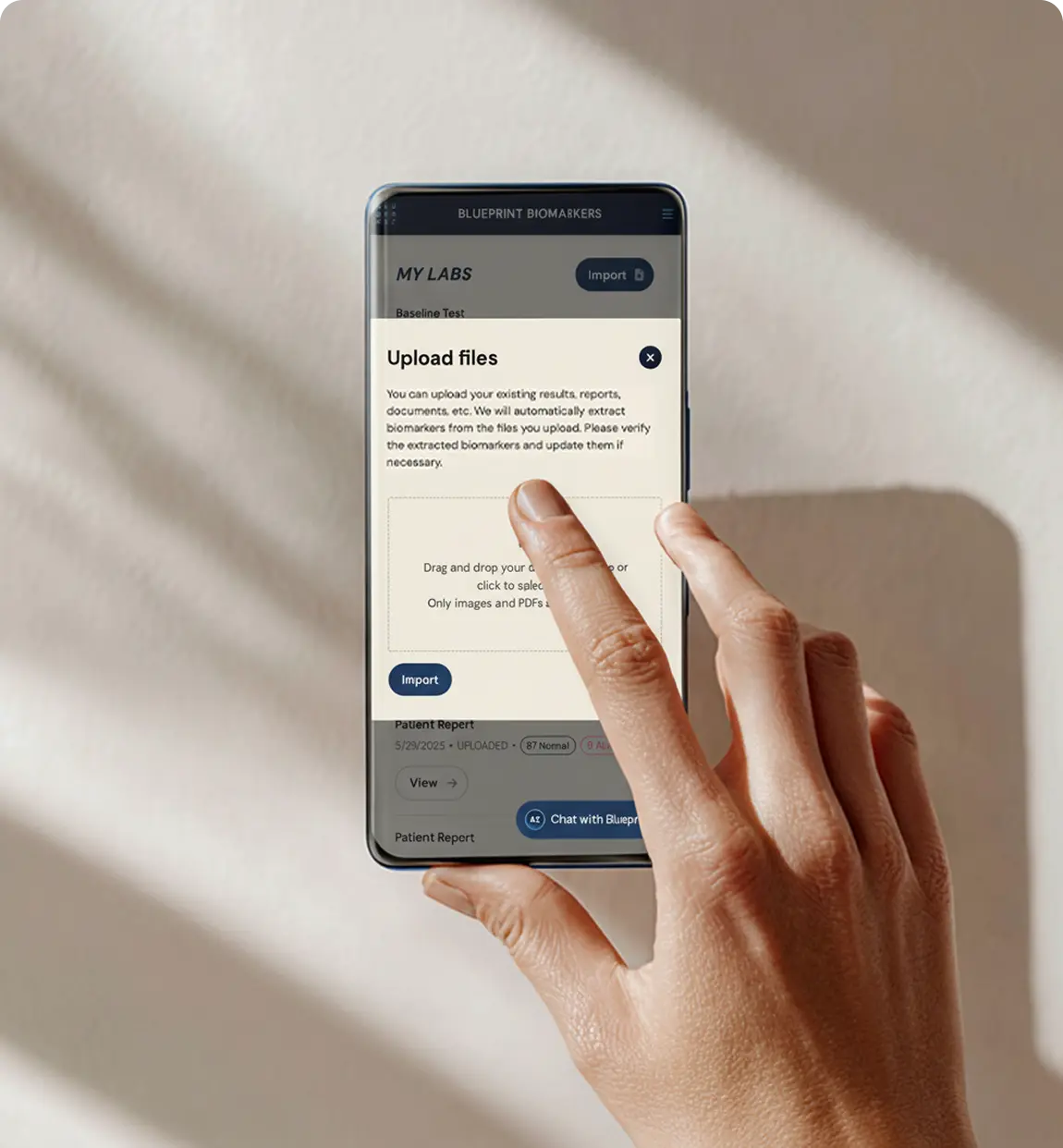 Hand holding a phone on an upload files screen